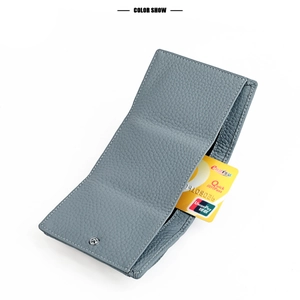 Detail view of light blue leather wallet with pebbled texture and functional card slots