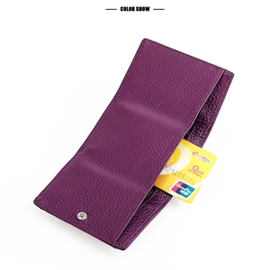 Detail of purple grain leather wallet featuring credit card slot and silver snap button