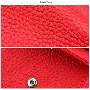 Macro detail of red lychee textured leather wallet showing silver magnetic snap and stitching