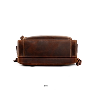 Side view of retro brown leather crossbody bag with detailed contrast stitching