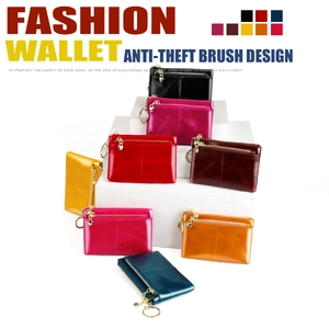 Detail of oil wax leather coin purses with RFID protection and heart-shaped zippers
