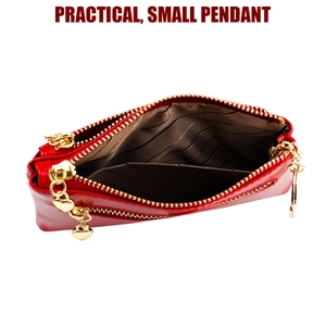 Macro view of red waxed leather coin purse featuring a gold heart pendant and zip closure