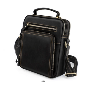 Side view of black vintage crazy horse leather crossbody bag with bold contrast stitching