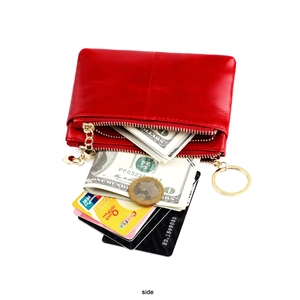 Macro detail of red oil wax leather coin purse with double zipper and card storage