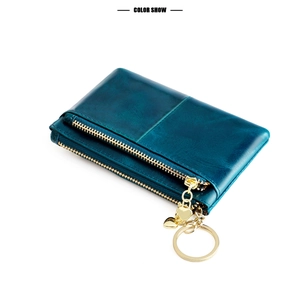 Detail of oil wax leather coin purse with double zippers and golden heart charm