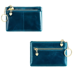 Detail of oil wax leather coin purses in navy blue with gold heart-shaped zippers