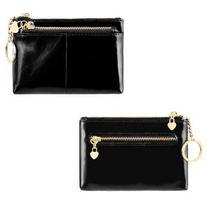 Detail of oil wax leather coin purse with gold zippers, heart charm and key ring