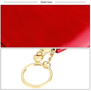 Detail of red oil wax leather coin purse with heart shaped gold hardware and keychain