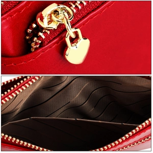 Detail of red wax leather coin purse with gold heart zipper and multi-layer interior