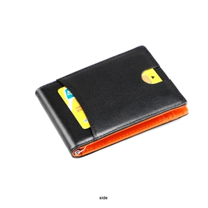 Detail of slim bifold wallet showing black and orange leather interior with metal money clip