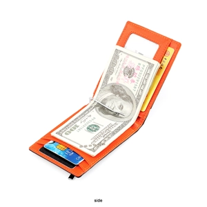 Detail of slim orange leather wallet featuring a metal money clip and card slots