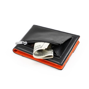Detail view of slim leather bifold wallet with orange interior and metal zipper pocket