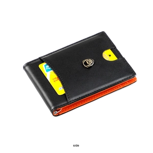 Detail of slim leather wallet with orange interior contrast and metal money clip