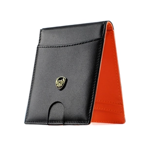 Detail of slim leather wallet showing black lychee grain texture and orange interior lining