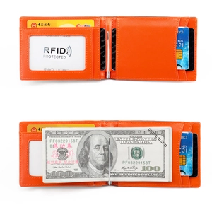 Internal detail of orange slim leather wallet showing RFID shielding and metal money clip