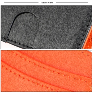 Macro view of slim wallet featuring black lychee grain leather and orange interior stitching
