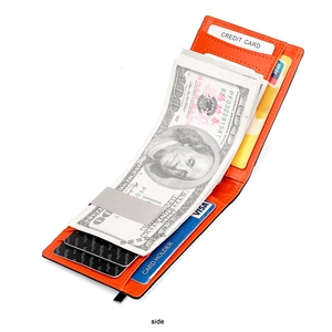 Detail of slim orange leather wallet featuring a sturdy silver money clip and card slots