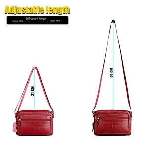 Detail of red genuine leather bag with adjustable shoulder strap and zip pockets