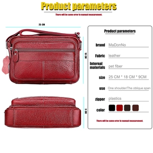 Macro view of red litchi texture leather crossbody bag with dual zipper design details