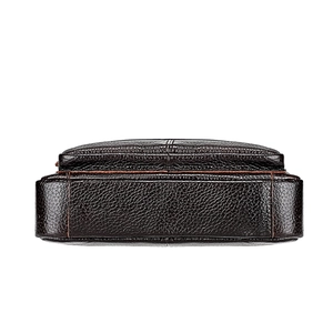 Detail of the high-quality brown cowhide leather texture and stitching on the bag base
