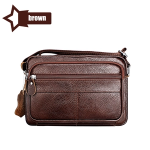 Detailed view of a brown pebbled leather shoulder bag featuring multiple zippered compartments