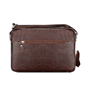 Close-up of brown genuine leather texture and front zipper pocket on crossbody bag