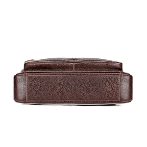 Close-up of dark brown top grain leather texture and stitching on handbag base