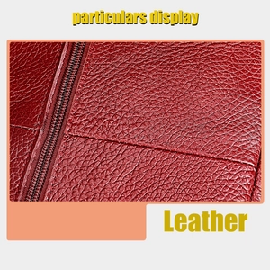 Macro shot of red pebbled leather bag detailing fine stitching and high-quality zipper