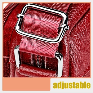 Close-up of red lychee grain leather handbag with adjustable silver metal strap buckle