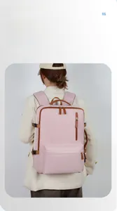 Detailed view of large capacity pink backpack with brown leather trim and front pocket