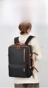 Close-up of black Oxford business backpack with USB charging port and brown leather trim