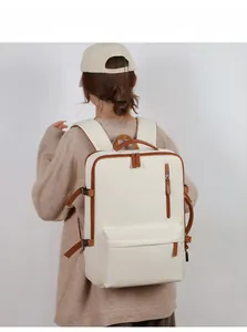Rear view of model wearing cream and brown oxford business laptop backpack