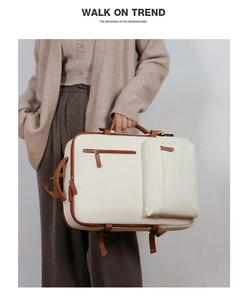 Detail of versatile cream business backpack with brown leather trim and multiple handles