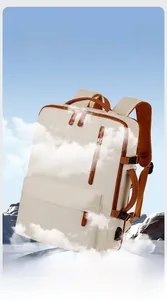 Detail of white Oxford backpack with USB charging port and brown leather trim accents