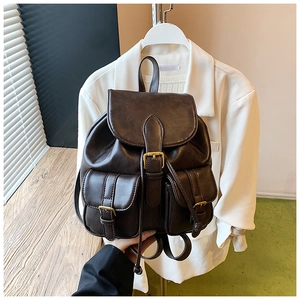 Primer plano detallado de la mochila vintage de cuero sintético marrón con hebillas