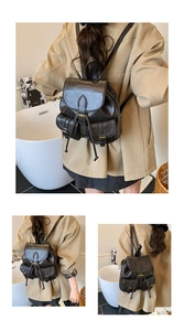 Close-up of retro black leather backpack with drawstring closure and bronze buckle detail