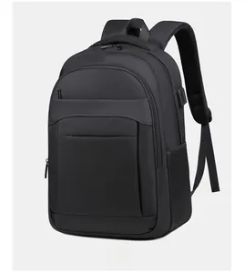 Detail view of the external USB charging port on a black durable laptop backpack