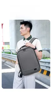Detail of grey men's backpack showing leather stitching and durable oxford material