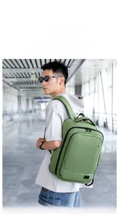 Close-up of sage green waterproof backpack with thick double handles and durable zippers
