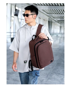 Macro detail of dark brown textured fabric and sleek black zippers on business backpack