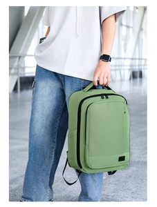 Detail of light green laptop backpack with black zipper and minimalist logo label