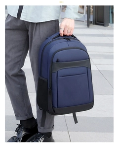 Detail of dark blue laptop backpack featuring reinforced handle and waterproof nylon texture