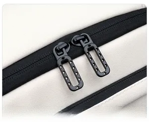 Detail of dual smooth black metal zippers on a cream canvas backpack with precise stitching