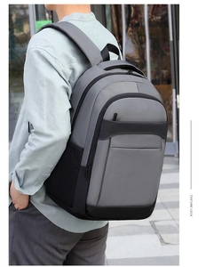 Ergonomic laptop backpack with grey and black patchwork design shown on model