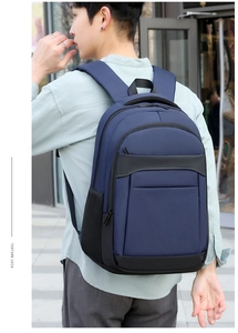 Side view of a deep blue business laptop backpack with padded straps on a model