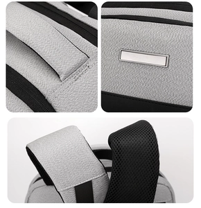 Détail du sac à bandoulière gris montrant la poignée renforcée et les bretelles respirantes