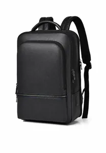 Detail of black pebbled leather business backpack featuring dual silver zippers and USB port