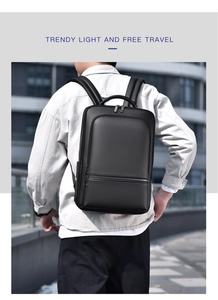 Modern black leather business backpack with lychee texture worn in an urban street setting