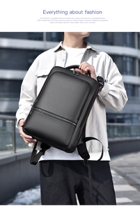 Detail of black business backpack with pebble leather texture and durable metal zippers