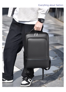Close-up of black lychee grain leather backpack with silver zippers in urban outdoor setting